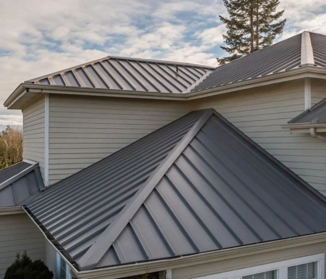 Close up of charcoal standing seam metal roof panels and hip seams on a residential roof