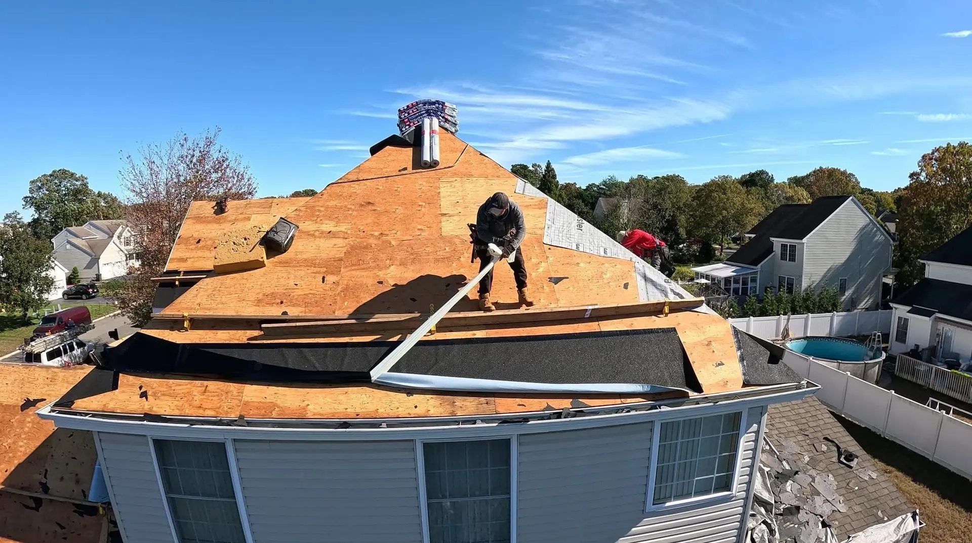 Dam Good Roofing crew installing new plywood decking and underlayment during a roof replacement in Ocean County, NJ